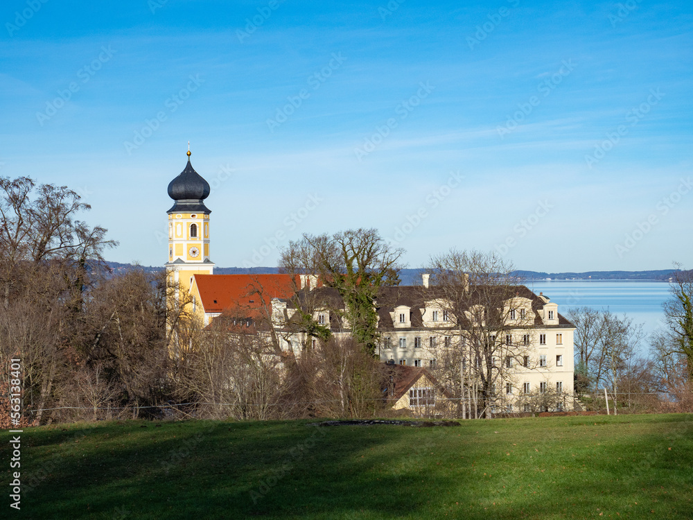 Bernrried, Germany - December 30th 2022: View towards the monastery with historic church tower Bernrried, Germany - December 30th 2022: View towards the monastery with historic church tower