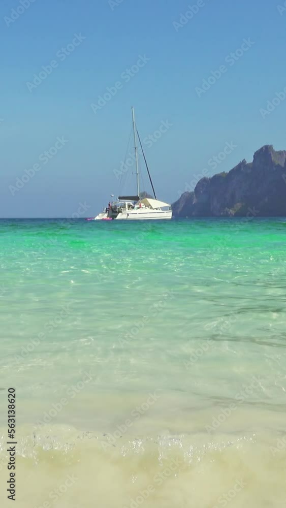Beautiful sea beach with white sand and boats in the bay, Thailand. Vertical video Beautiful sea beach with white sand and boats in the bay, Thailand. Vertical video