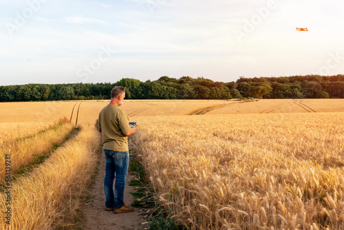 Bearded man using a drone with remote controller  making photos and videos   having fun with new  technology trends