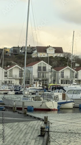 Vertical Timelapse of a small marina with boats on the coast of western Norway photo