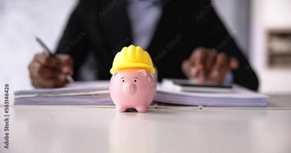 Piggy Bank With Construction Hard Hat - obrazy, fototapety, plakaty 