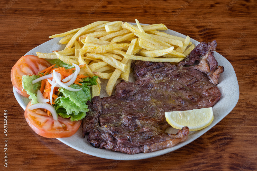 A traditional Portuguese dish of roasted black pig meat and fried potatoes. Bife de vazia