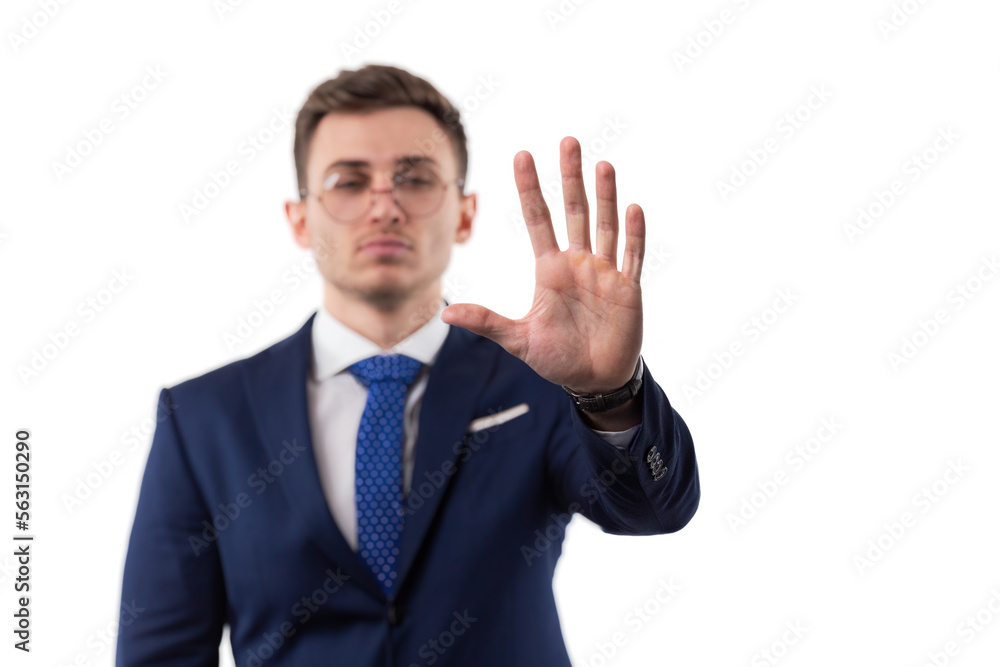 A man in a suit and tie makes a stop gesture with his hand showing his palm. On a white isolated background.. blurred A man in a suit and tie makes a stop gesture with his hand showing his palm. On a white isolated background.. blurred