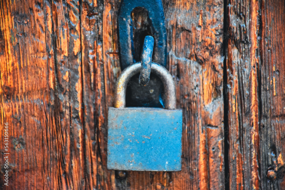 Old rusty lock hook and padlock on wooden door. Old rustic wooden door with padlock vintage concept Old rusty lock hook and padlock on wooden door. Old rustic wooden door with padlock vintage concept