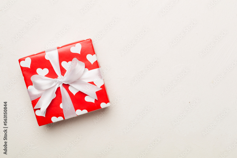 Gift box with hearts on concrete background, top view Gift box with hearts on concrete background, top view