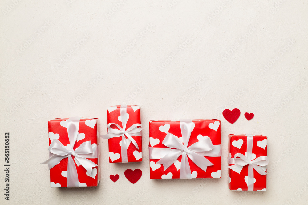 Gift boxes with hearts on concrete background, top view Gift boxes with hearts on concrete background, top view