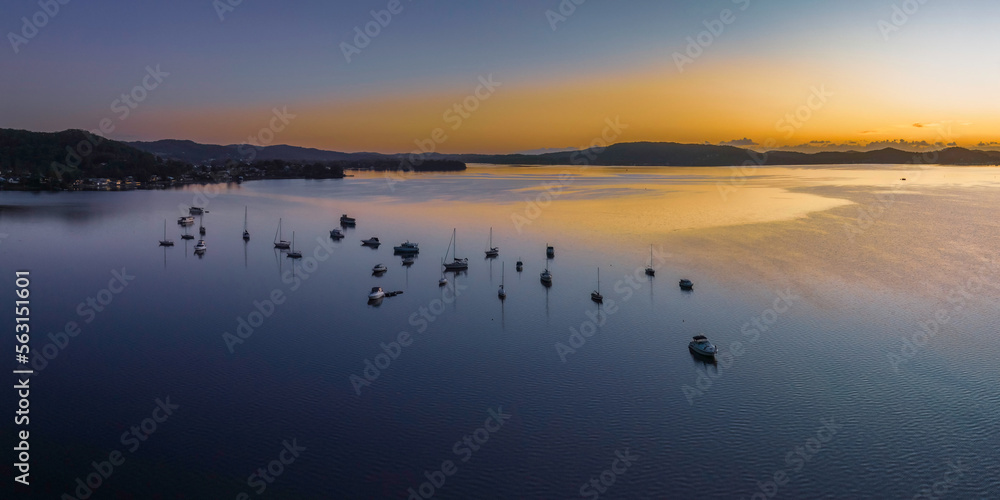 Aerial sunrise waterscape over the bay with boats