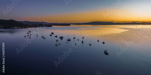 Aerial sunrise waterscape over the bay with boats