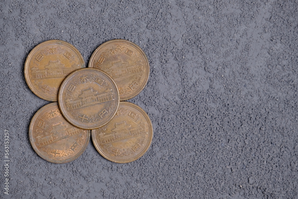 10 japanese yens coins on grey background 10 japanese yens coins on grey background