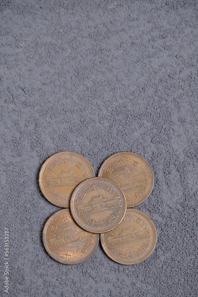 10 japanese yens coins on grey background 10 japanese yens coins on grey background