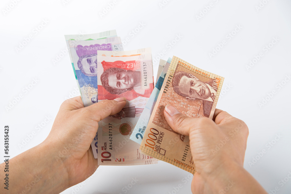counting Colombian banknotes, white background counting Colombian banknotes, white background