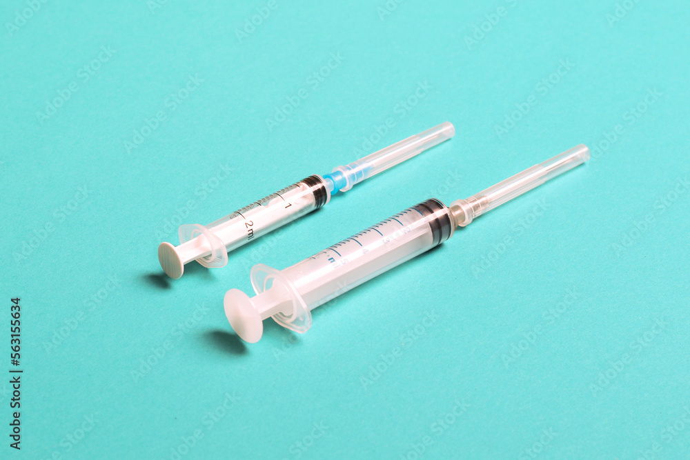 Top view of different syringes for injection on colorful background. Medical equipment concept with copy space Top view of different syringes for injection on colorful background. Medical equipment concept with copy space