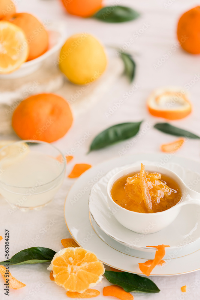 Fresh bitter orange marmalade with ripe fruit offered as closeup on a rustic black board with copy space Fresh bitter orange marmalade with ripe fruit offered as closeup on a rustic black board with copy space