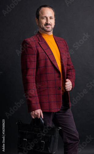 cheerful stylish man hold briefcase in studio. briefcase for trendy man. photo of mature man