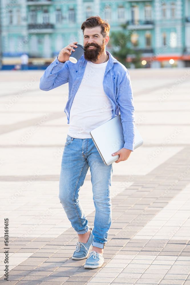 Fototapeta premium guy talk on smartphone walking in the street. photo of guy talk on smartphone.