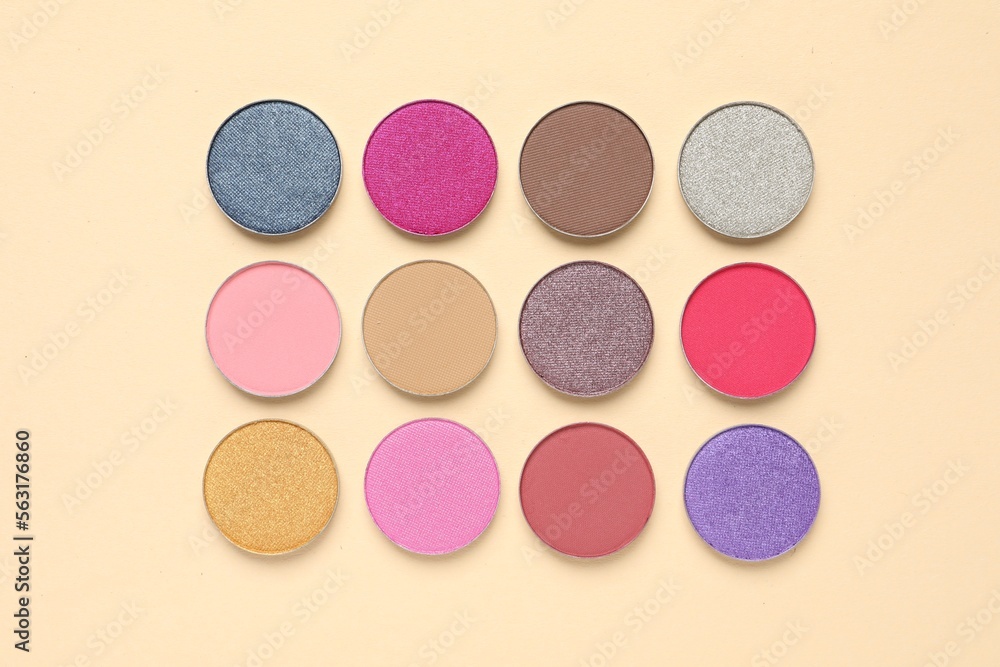 Different beautiful eye shadows on beige background, flat lay Different beautiful eye shadows on beige background, flat lay