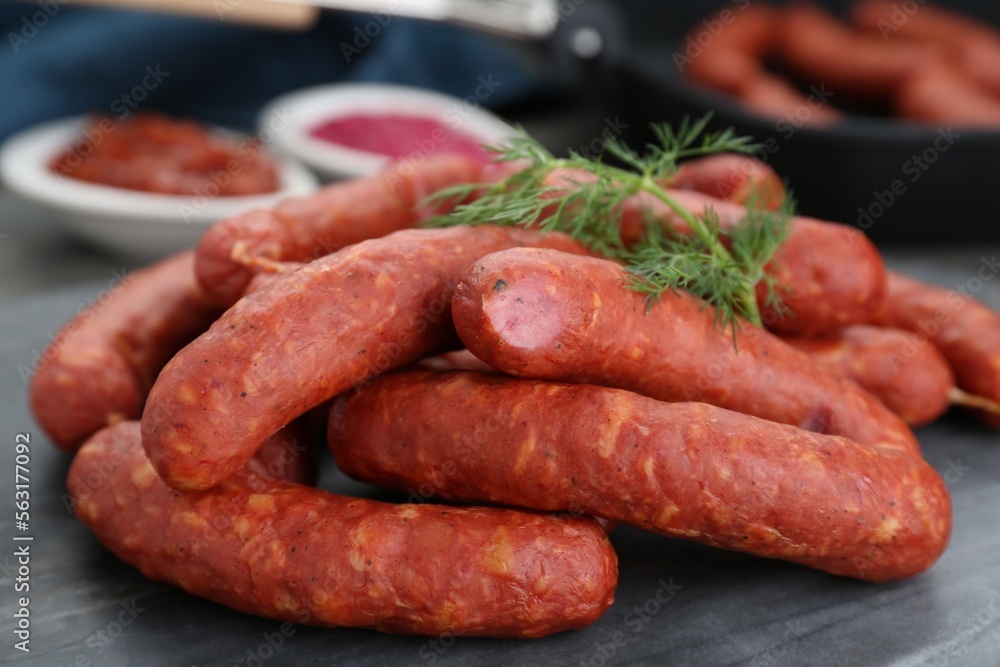 Delicious sausages and dill on grey table, closeup