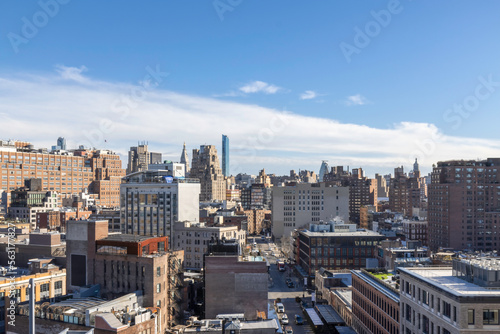 High view of lower Manhattan looking north, buildings, streets, traffic, blue sky and clouds, sunny, nobody
