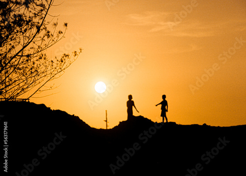 silhouette of two kids