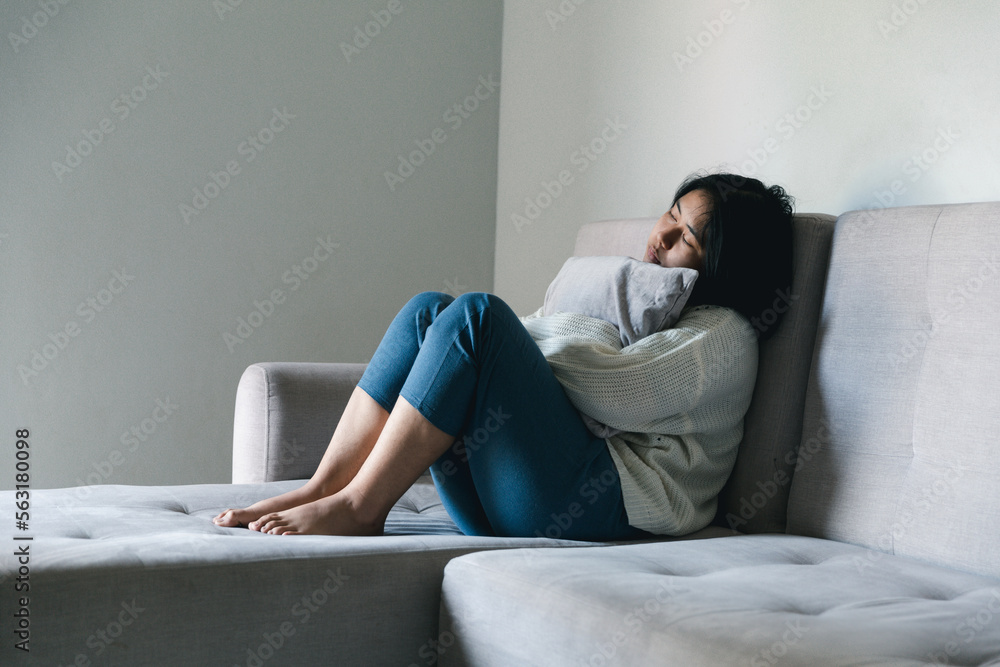 Concept of sad teenage girl depression. Upset teenage girl sitting at window indoors. Anxiety young woman Despair and stress. Lonely and unhappy female are social victims. loneliness youth in home. Concept of sad teenage girl depression. Upset teenage girl sitting at window indoors. Anxiety young woman Despair and stress. Lonely and unhappy female are social victims. loneliness youth in home.