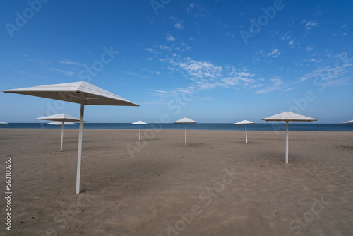 A deserted beach with wooden umbrellas on the shore of the Baltic Sea in the village of Yantarny  Kaliningrad region  Russia