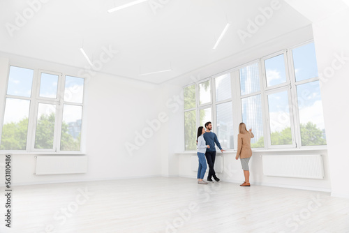 Real estate agent showing new apartment to couple