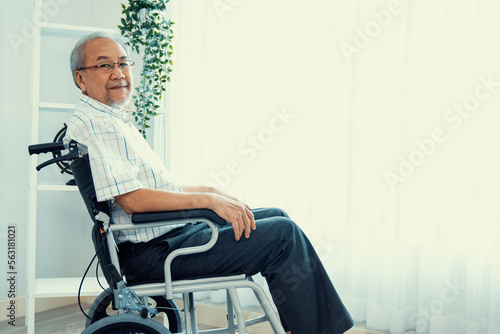 Tableau sur toile Portrait of an elderly man in a wheelchair alone with himself at home but contented with his lot in life