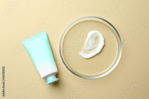 Petri dish and cosmetic product on beige background, flat lay