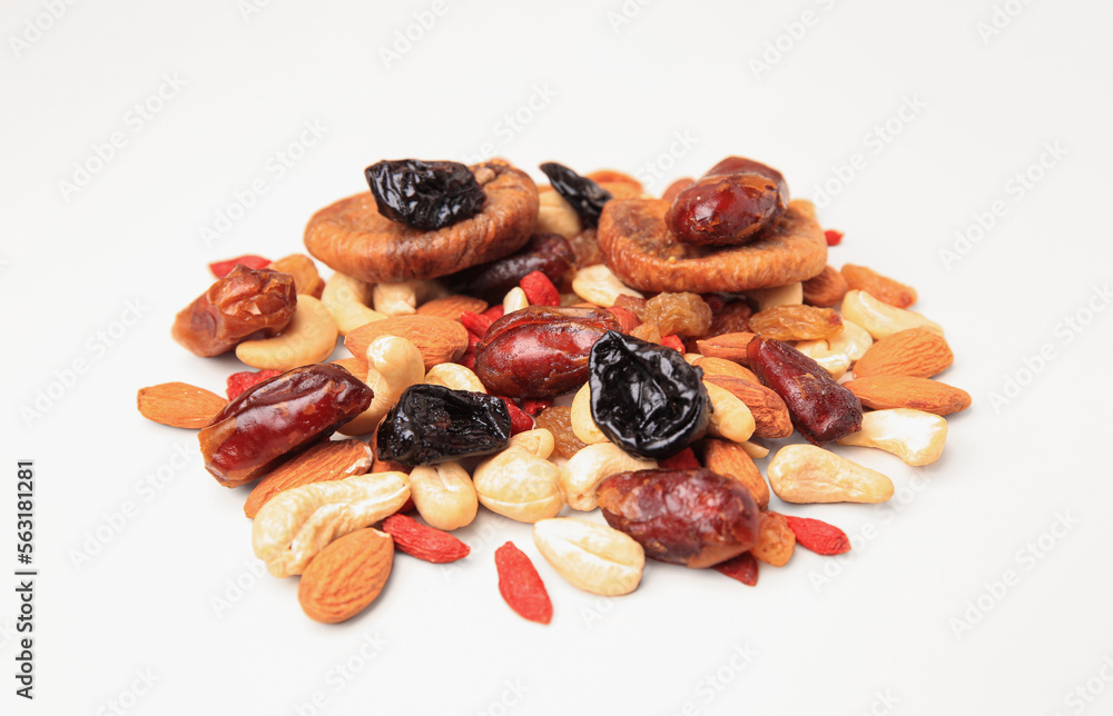 Pile of mixed dried fruits and nuts on white background, closeup