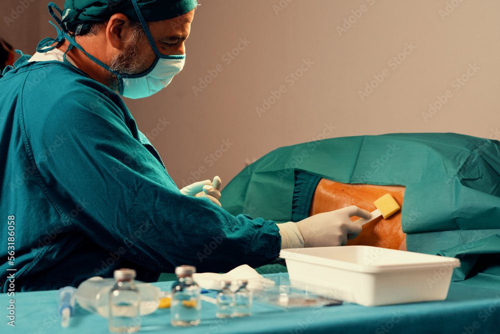 Doctor or surgeon apply betadine to the patient for anesthesia