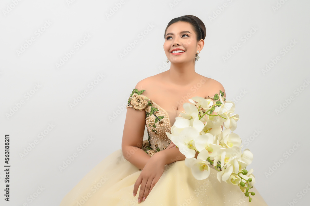 Young asian beautiful bride with orchid bouquet on white background Young asian beautiful bride with orchid bouquet on white background