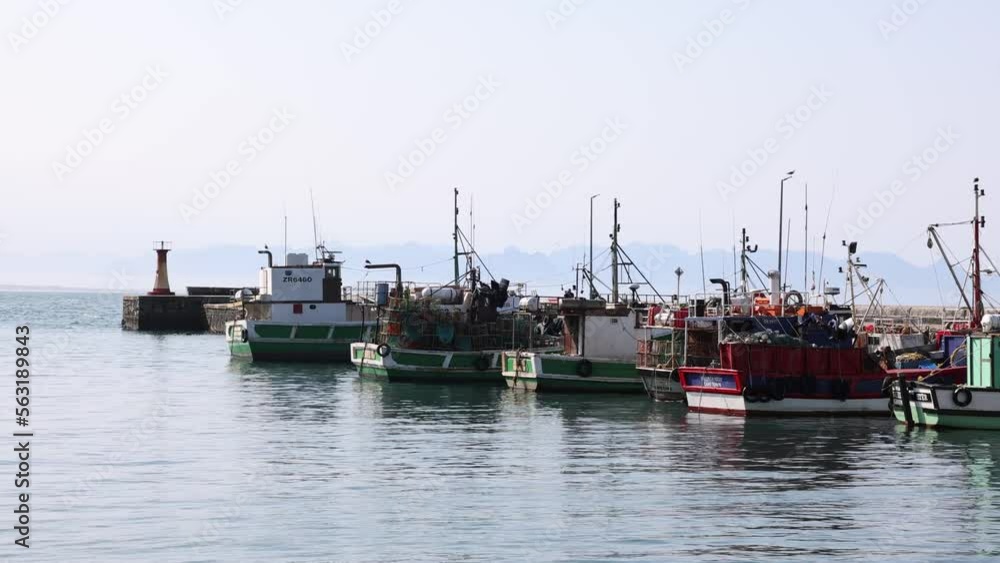 Fishing Boats Docked In Harbor Sunny Day Mountains In Background Fishing Boats Docked In Harbor Sunny Day Mountains In Background