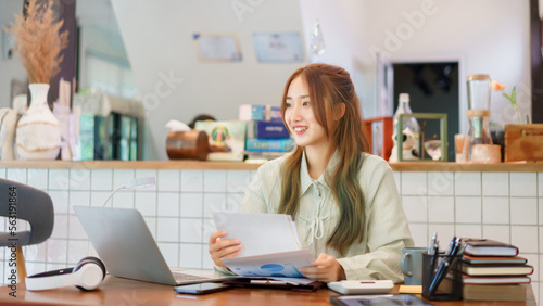 Business concept, Woman entrepreneur holding document and looking outside in coworking space office