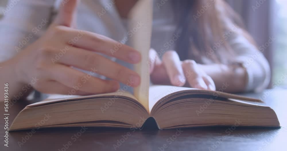 Close up hand and finger of woman reading and open book page for education on table.Learning by yourself with knowledge textbook.Lifestyle of people relax reading magazine in library on holiday. Close up hand and finger of woman reading and open book page for education on table.Learning by yourself with knowledge textbook.Lifestyle of people relax reading magazine in library on holiday.