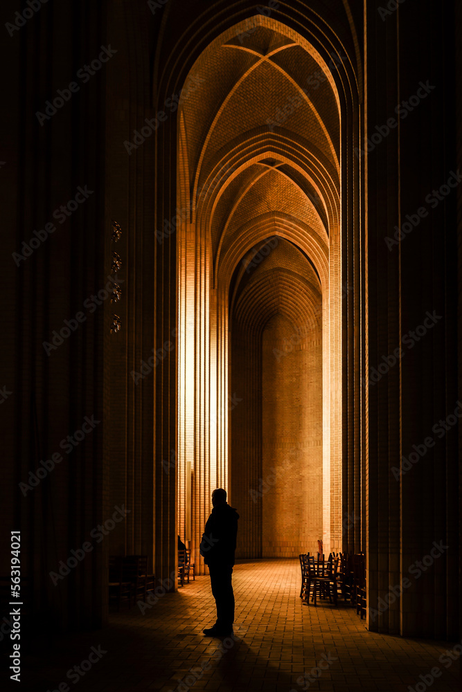 Copenhagen, Denmark  A man stands in the interior of the landmark Gruntvig Church in the Bispebjerg district.
