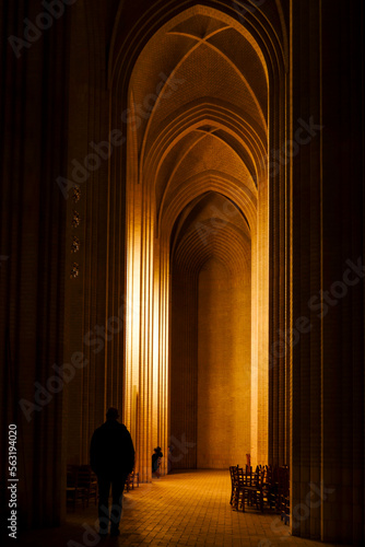 Copenhagen, Denmark  A man stands in the interior of the landmark Gruntvig Church in the Bispebjerg district. photo