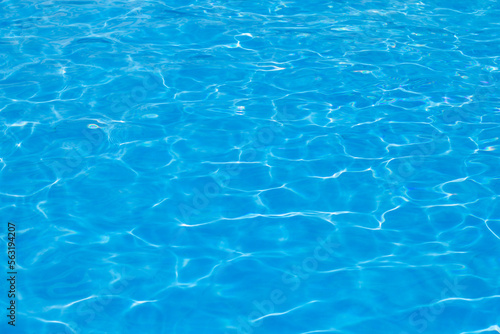 Abstract texture of blue water in the pool. Stylish concept of rest in summer and in the hotel