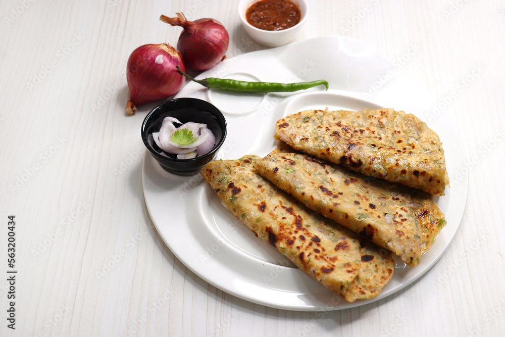 Indian traditional Hot Onion Paratha with tomato chutney. Indian onion stuffed Flatbread. also