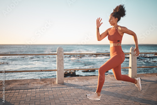 Sprinting, running and woman training by the beach for fitness, cardio and exercise in Thailand. Commitment, sports and latino runner on the promenade for a workout, start of a race or marathon