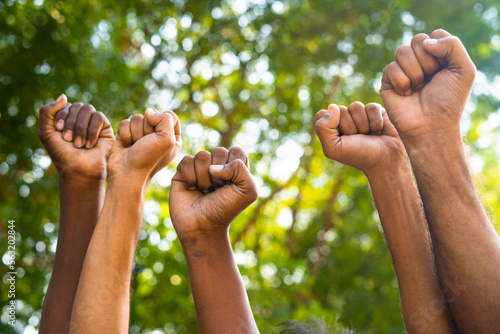Fotografia Concept of unity in diversity or equality showing by Group of fist hands rising