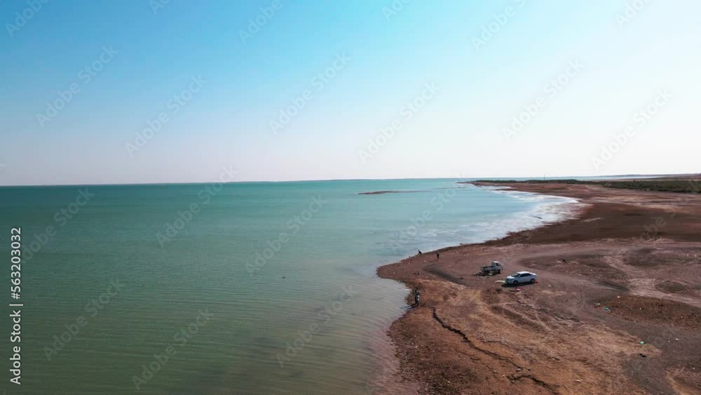 Drone flies over fishermen on the shore of the lake Drone flies over fishermen on the shore of the lake