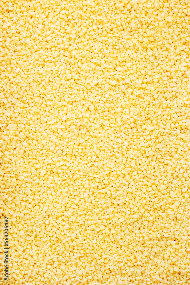Couscous, dry wheat grain, food background texture, top view