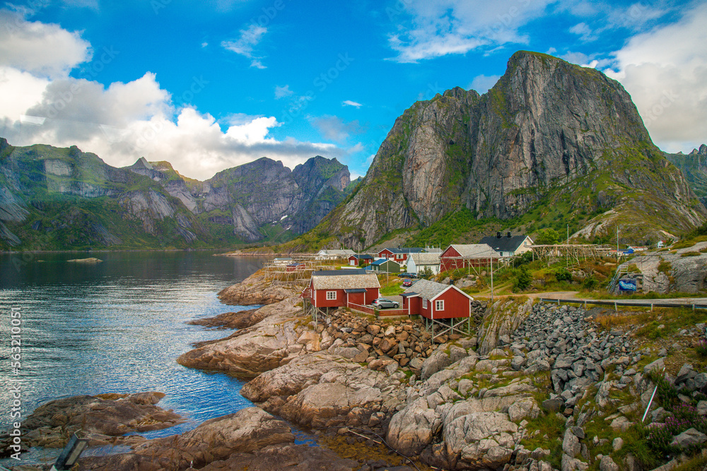 Red houses along a shoreline in Arctic Norway.
