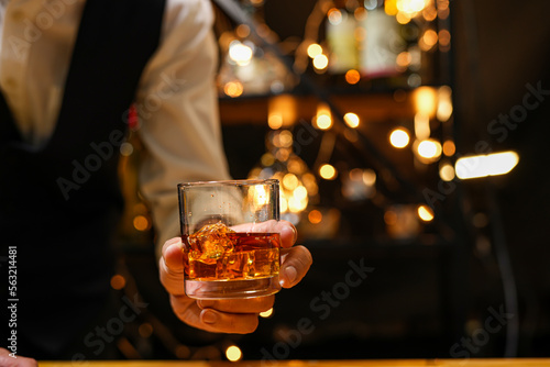 Bartender pouring Whiskey, on bar,