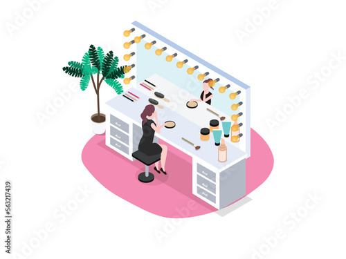 Young woman applying foundation makeup while sitting in the backstage room