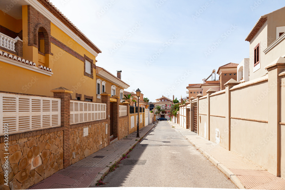 Spanish street in Motril city with private houses along the street.