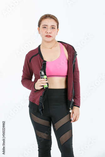 Portrait isolated cutout full body studio shot of Asian fit strong female athlete model in cropped top sport bra and outer jacket with legging and running shoes standing posing on white background