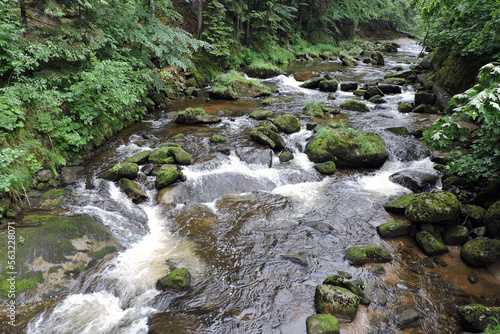 A wonderful view of a mountain creek called Szklarka  some rocks in a brook in the forest in the Karkonosze Mountains in Poland