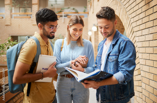 University, students and friends reading study book for project, education or sharing information together at campus. Group of college people with textbook for learning, knowledge or scholarship photo