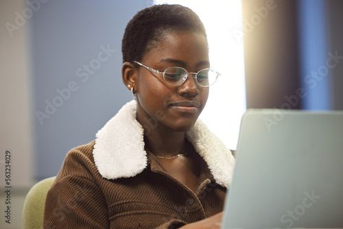 Student, laptop or research in university education, school learning or college scholarship goals in library classroom. Smile, happy or black woman on technology for studying degree or thesis writing photo